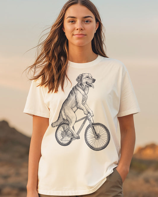 Golden Retriever dog cycling on a vintage bicycle engraving-style natural color T-shirt design
