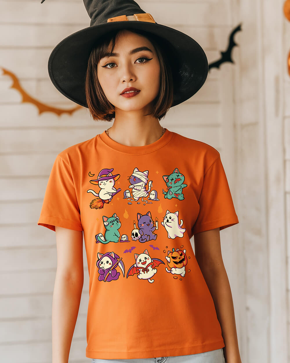 Halloween-themed t-shirt with nine costumed cats in spooky poses