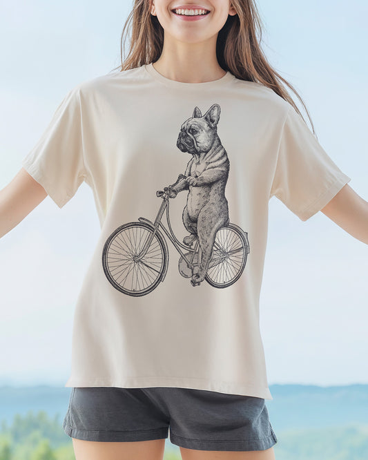 French Bulldog cycling on a vintage bicycle engraving-style natural color T-shirt design