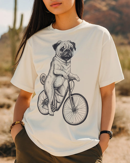 Pug cycling on a vintage bicycle engraving-style natural color T-shirt design